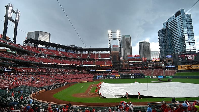 Jun 27, 2021; St. Louis, Missouri, USA; St. Louis Cardinals grounds crew places the tarp on the field during a rain delay in the sixth inning against the Pittsburgh Pirates at Busch Stadium. Mandatory Credit: Jeff Curry-USA TODAY Sports