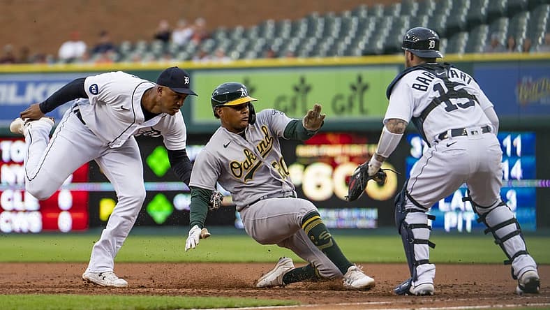 May 11, 2022; Detroit, Michigan, USA; Detroit Tigers second baseman Jonathan Schoop (7) tags out Oakland Athletics center fielder Cristian Pache (20) before he gets back to first base during the second inning at Comerica Park. Mandatory Credit: Raj Mehta-USA TODAY Sports