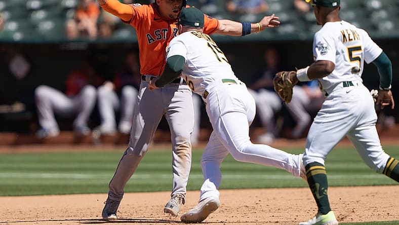 Jun 1, 2022; Oakland, California, USA; Houston Astros second baseman Aledmys Diaz (16) gets tagged out by Oakland Athletics left fielder Seth Brown (15) during the ninth inning at RingCentral Coliseum. Mandatory Credit: Stan Szeto-USA TODAY Sports