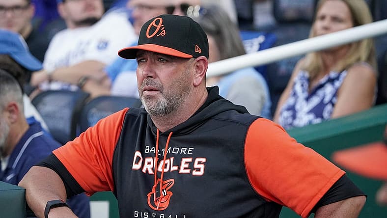 Jun 10, 2022; Kansas City, Missouri, USA; Baltimore Orioles manager Brandon Hyde (18) looks out from the dugout against the Kansas City Royals prior to the game at Kauffman Stadium. Mandatory Credit: Denny Medley-USA TODAY Sports