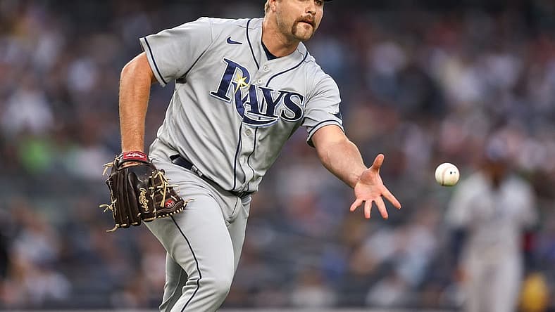 Jun 16, 2022; Bronx, New York, USA; Tampa Bay Rays starting pitcher Jalen Beeks (68) tosses the ball to first base for an out during the first inning against the New York Yankees at Yankee Stadium. Mandatory Credit: Vincent Carchietta-USA TODAY Sports