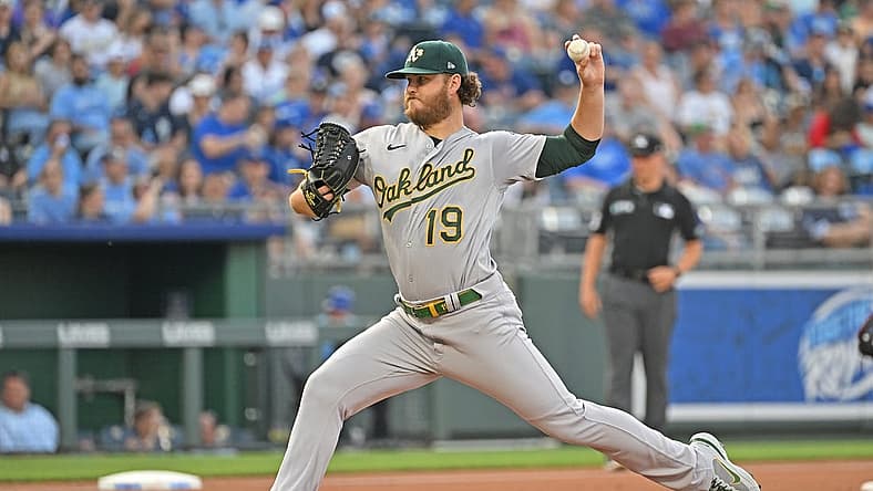 Jun 24, 2022; Kansas City, Missouri, USA; Oakland Athletics starting pitcher Cole Irvin (19) delivers a pitch during the first inning against the Kansas City Royals at Kauffman Stadium. Mandatory Credit: Peter Aiken-USA TODAY Sports