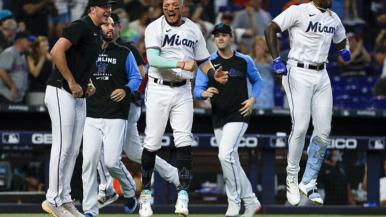 Jun 26, 2022; Miami, Florida, USA; Miami Marlins shortstop Miguel Rojas (11) reacts after a walk-off home run from catcher Nick Fortes (not pictured) in the ninth inning against the New York Mets at loanDepot Park. Mandatory Credit: Sam Navarro-USA TODAY Sports
