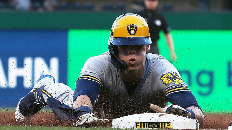 Jun 30, 2022; Pittsburgh, Pennsylvania, USA; Milwaukee Brewers left fielder Christian Yelich (22) slides safely into third base with an RBI triple against the Pittsburgh Pirates during the third inning at PNC Park. Mandatory Credit: Charles LeClaire-USA TODAY Sports