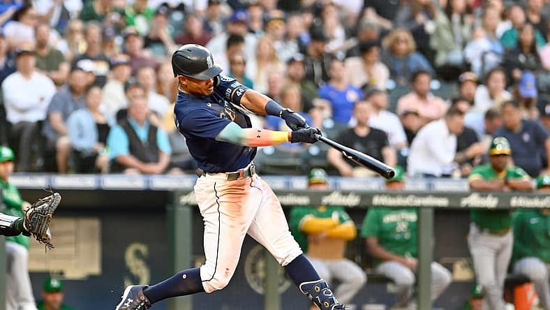 Jun 30, 2022; Seattle, Washington, USA; Seattle Mariners center fielder Julio Rodriguez (44) hits a home run against the Oakland Athletics during the third inning at T-Mobile Park. Mandatory Credit: Steven Bisig-USA TODAY Sports
