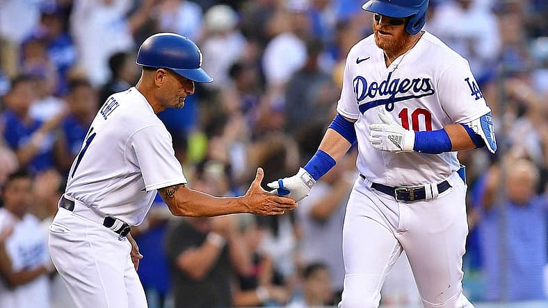Jun 30, 2022; Los Angeles, California, USA; Los Angeles Dodgers third baseman Justin Turner (10) is greeted by third base coach Dino Ebel (91) after hitting a solo home run against the San Diego Padres during the second inning at Dodger Stadium. Mandatory Credit: Gary A. Vasquez-USA TODAY Sports