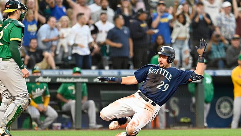 Jun 30, 2022; Seattle, Washington, USA; Seattle Mariners catcher Cal Raleigh (29) scores a run on an error after hitting a two-RBI triple against the Oakland Athletics during the fifth inning at T-Mobile Park. Mandatory Credit: Steven Bisig-USA TODAY Sports