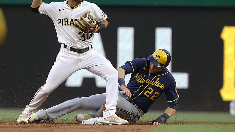 Jul 1, 2022; Pittsburgh, Pennsylvania, USA; Pittsburgh Pirates second baseman Tucupita Marcano (30) throws to first base after a force out of Milwaukee Brewers left fielder Christian Yelich (22) at second base during the second inning at PNC Park. Mandatory Credit: Charles LeClaire-USA TODAY Sports