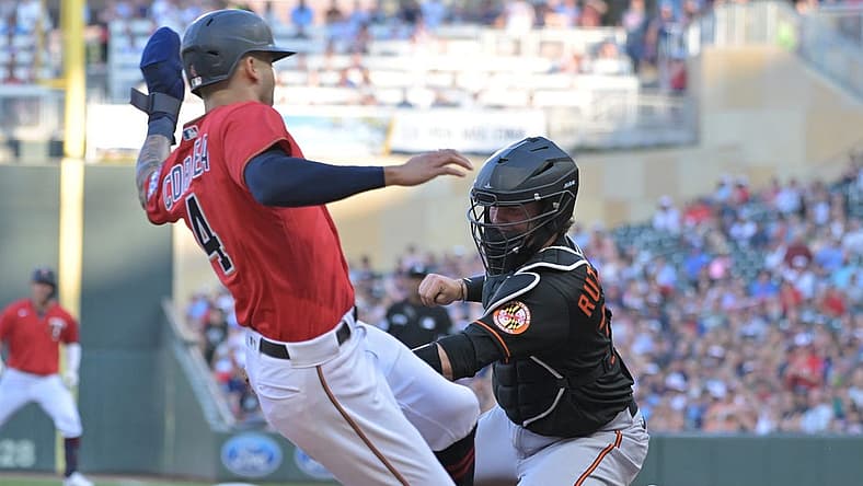Jul 1, 2022; Minneapolis, Minnesota, USA; Baltimore Minnesota Twins shortstop Carlos Correa (4) is tagged out at home by Baltimore Orioles catcher Adley Rutschman (35) on an RBI single by Minnesota Twins first baseman Jose Miranda (not pictured) during the first inning at Target Field. Mandatory Credit: Jeffrey Becker-USA TODAY Sports