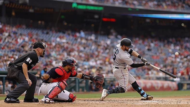 Jul 1, 2022; Washington, District of Columbia, USA; Miami Marlins third baseman Jon Berti (5) hits a sacrifice fly RBI against the Washington Nationals during the fifth inning at Nationals Park. Mandatory Credit: Geoff Burke-USA TODAY Sports