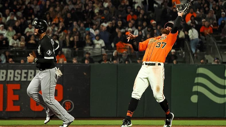 Jul 1, 2022; San Francisco, California, USA; San Francisco Giants shortstop Donovan Walton (37) makes a catch near Chicago White Sox first baseman Jose Abreu (79) during the sixth inning at Oracle Park. Mandatory Credit: Kelley L Cox-USA TODAY Sports