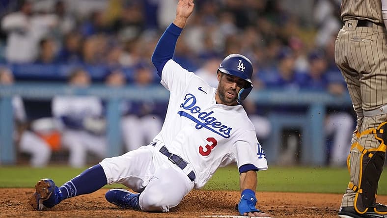 Jul 1, 2022; Los Angeles, California, USA; Los Angeles Dodgers left fielder Chris Taylor (3) slides into home plate to score in the eighth inning against the San Diego Padres at Dodger Stadium. Mandatory Credit: Kirby Lee-USA TODAY Sports