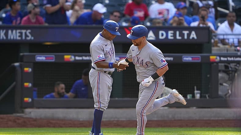 Jul 2, 2022; New York City, New York, USA; Texas Rangers right fielder Kole Calhoun (56) is congratulated by third base coach Tony Beasley (27) as he rounds the bases after hitting a home run during the fourth inning at Citi Field. Mandatory Credit: Gregory Fisher-USA TODAY Sports