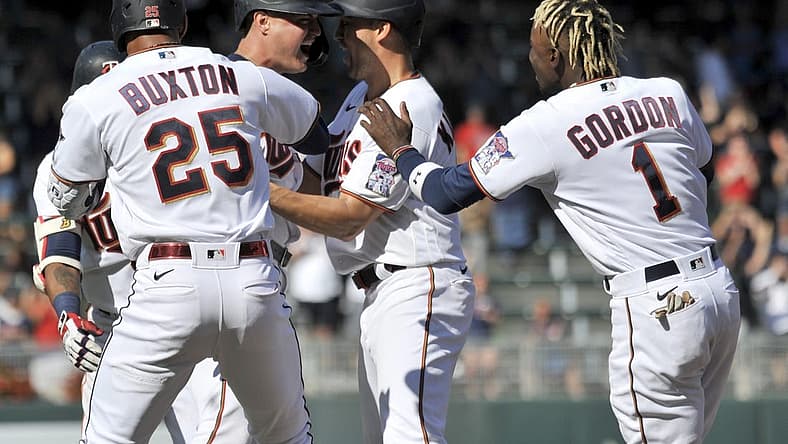 Jul 2, 2022; Minneapolis, Minnesota, USA; Minnesota Twins pinch hitter Jose Miranda (left center) reacts with center fielder Nick Gordon (1), designated hitter Byron Buxton (25), left fielder Alex Kirilloff (right center) and teammates after hitting a walk off single against Baltimore Orioles relief pitcher Jorge Lopez (not pictured) during the ninth inning at Target Field. Mandatory Credit: Jeffrey Becker-USA TODAY Sports