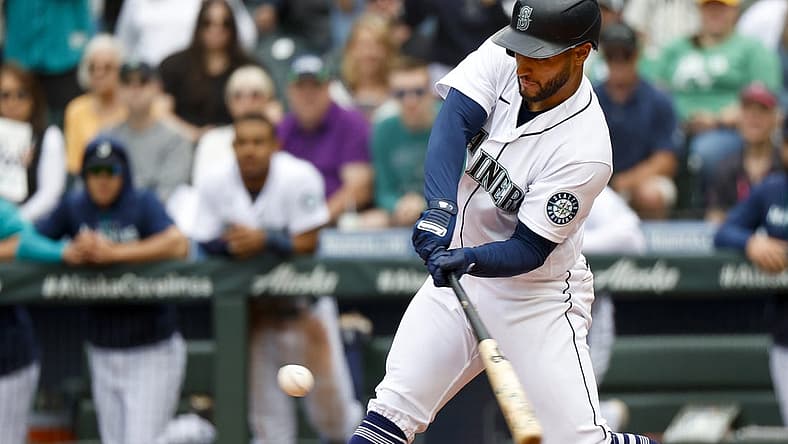 Jul 2, 2022; Seattle, Washington, USA; Seattle Mariners third baseman Abraham Toro (13) hits a walk-off RBI-single against the Oakland Athletics during the ninth inning at T-Mobile Park. Seattle defeated Oakland, 2-1. Mandatory Credit: Joe Nicholson-USA TODAY Sports
