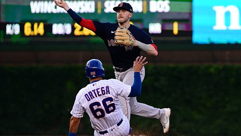 Jul 2, 2022; Chicago, Illinois, USA; Boston Red Sox second baseman Trevor Story (10) turns a double play in the third inning against the Chicago Cubs at Wrigley Field. Mandatory Credit: Quinn Harris-USA TODAY