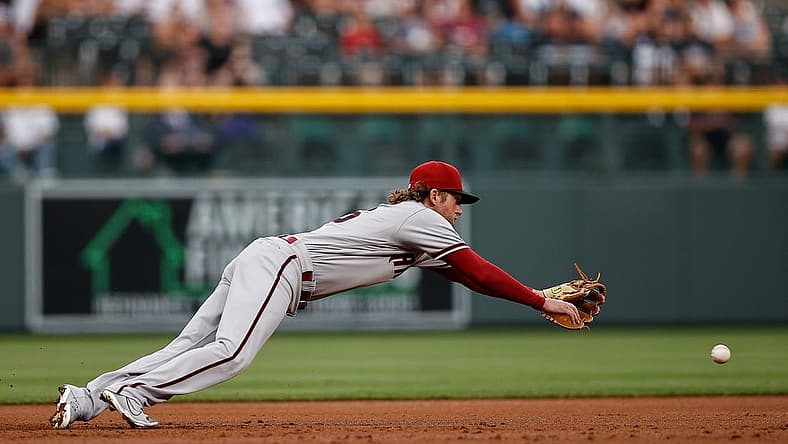 Jul 2, 2022; Denver, Colorado, USA; Arizona Diamondbacks third baseman Jake Hager (16) is unable to field a ground ball in the first inning against the Colorado Rockies at Coors Field. Mandatory Credit: Isaiah J. Downing-USA TODAY Sports