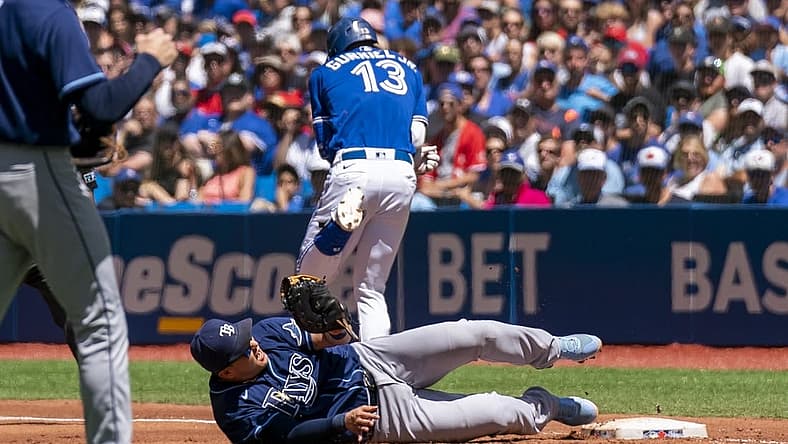 Jul 3, 2022; Toronto, Ontario, CAN; Tampa Bay Rays first baseman Ji-Man Choi (26) tags out Toronto Blue Jays left fielder Lourdes Gurriel Jr. (13) at first base during the second inning at Rogers Centre. Mandatory Credit: Kevin Sousa-USA TODAY Sports