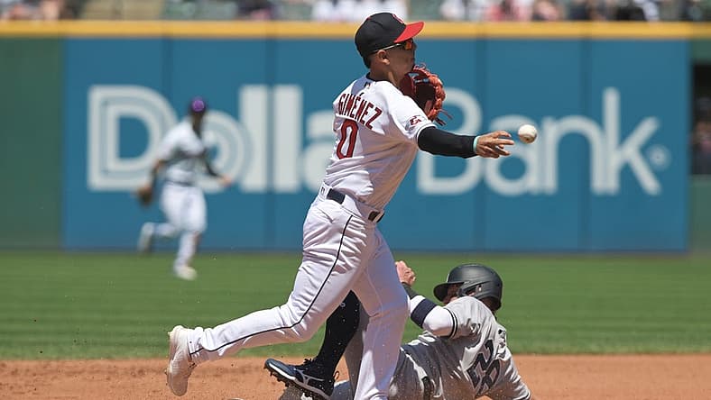Jul 3, 2022; Cleveland, Ohio, USA; Cleveland Guardians second baseman Andres Gimenez (0) forces out New York Yankees third baseman Josh Donaldson (28) during the fourth inning at Progressive Field. Mandatory Credit: Ken Blaze-USA TODAY Sports