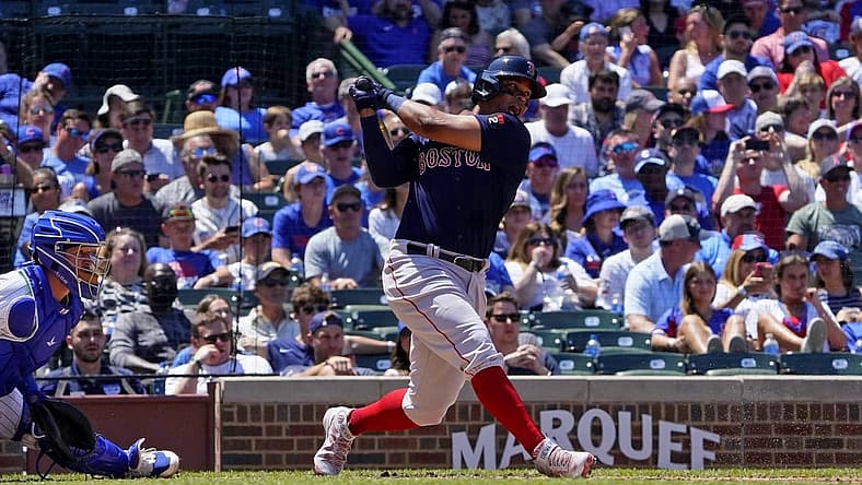 Jul 3, 2022; Chicago, Illinois, USA; Boston Red Sox third baseman Rafael Devers (11) hits an infield single against the Chicago Cubs during the third inning at Wrigley Field. Mandatory Credit: David Banks-USA TODAY Sports