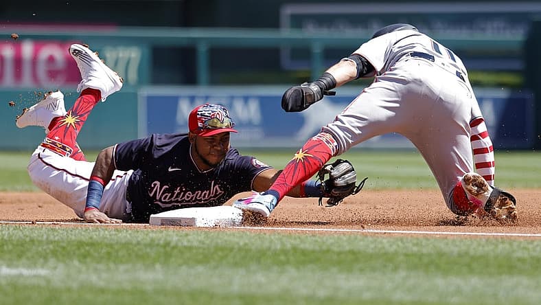 Jul 4, 2022; Washington, District of Columbia, USA; Miami Marlins shortstop Miguel Rojas (11) is tagged out by Washington Nationals third baseman Maikel Franco (7) while attempting to advance to third base on a single by Marlins third baseman Brian Anderson (not pictured) during the first inning at Nationals Park. Mandatory Credit: Geoff Burke-USA TODAY Sports