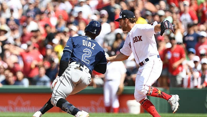 Jul 4, 2022; Boston, Massachusetts, USA; Boston Red Sox pitcher Kutter Crawford (50) tags out Tampa Bay Rays third baseman Yandy Diaz (2) during the fifth inning at Fenway Park. Mandatory Credit: Brian Fluharty-USA TODAY Sports