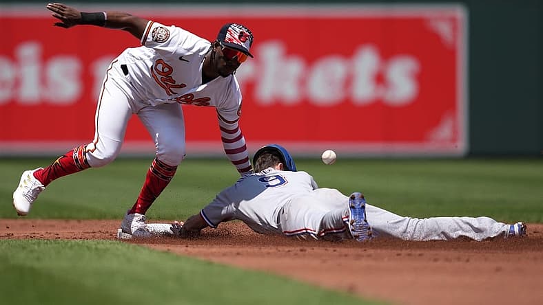 Jul 4, 2022; Baltimore, Maryland, USA; Texas Rangers outfielder Steven Duggar (9) steals second base in the second inning defended by Baltimore Orioles shortstop Jorge Mateo (3) at Oriole Park at Camden Yards. Mandatory Credit: Mitch Stringer-USA TODAY Sports