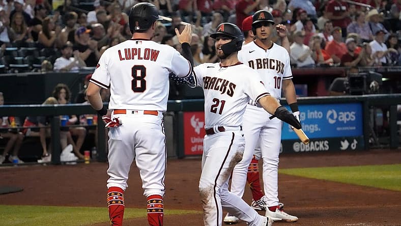 Jul 4, 2022; Phoenix, Arizona, USA; Arizona Diamondbacks left fielder Cooper Hummel (21) and right fielder Jordan Luplow (8) slap hands after scoring run against the San Francisco Giants during the first inning at Chase Field. Mandatory Credit: Joe Camporeale-USA TODAY Sports