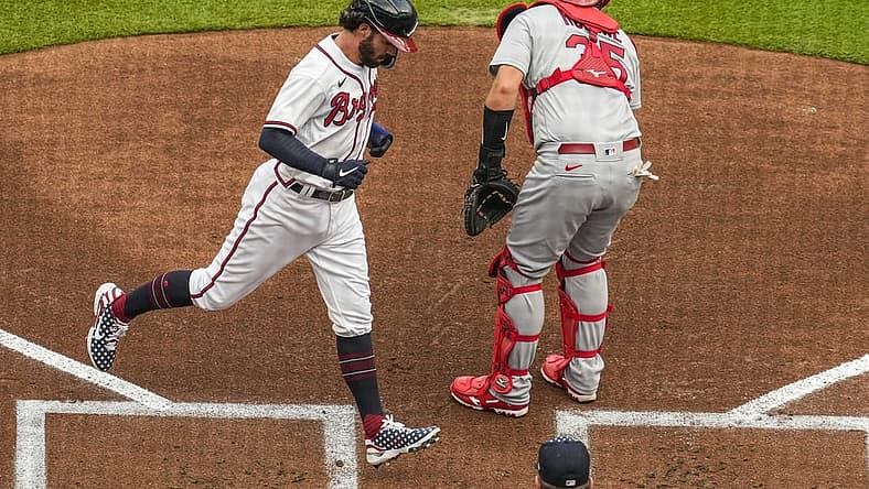 Jul 4, 2022; Cumberland, Georgia, USA; Atlanta Braves shortstop Dansby Swanson (7) scores a run behind St. Louis Cardinals catcher Austin Romine (35) during the first inning at Truist Park. Mandatory Credit: Dale Zanine-USA TODAY Sports