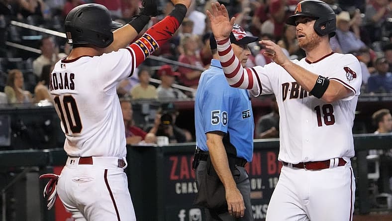 Jul 4, 2022; Phoenix, Arizona, USA; Arizona Diamondbacks third baseman Josh Rojas (10) and catcher Carson Kelly (18) celebrate after scoring runs against the San Francisco Giants during the eighth inning at Chase Field. Mandatory Credit: Joe Camporeale-USA TODAY Sports