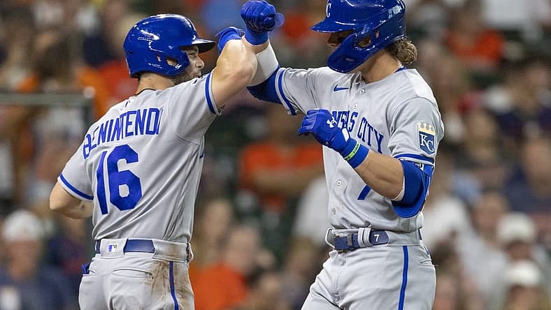 Jul 5, 2022; Houston, Texas, USA; Kansas City Royals left fielder Andrew Benintendi (16) celebrates shortstop Bobby Witt Jr. (7) two run home run against the Houston Astros in the third inning at Minute Maid Park. Mandatory Credit: Thomas Shea-USA TODAY Sports