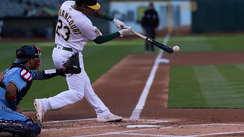 Jul 5, 2022; Oakland, California, USA; Oakland Athletics first baseman Christian Bethancourt (23) hits a RBI single during the first inning against the Toronto Blue Jays at RingCentral Coliseum. Mandatory Credit: Stan Szeto-USA TODAY Sports