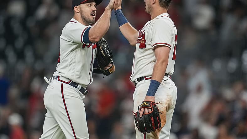 Jul 5, 2022; Cumberland, Georgia, USA; Atlanta Braves left fielder Adam Duvall (14) and third baseman Austin Riley (27) react after the Braves defeated the St. Louis Cardinals at Truist Park. Mandatory Credit: Dale Zanine-USA TODAY Sports