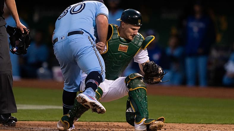 Jul 5, 2022; Oakland, California, USA; Toronto Blue Jays catcher Alejandro Kirk (30) collides with Oakland Athletics catcher Sean Murphy (12) during the sixth inning at RingCentral Coliseum. Mandatory Credit: Stan Szeto-USA TODAY Sports