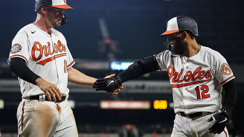 Jul 5, 2022; Baltimore, Maryland, USA; Baltimore Orioles first baseman Trey Mancini (16) celebrates with second baseman Rougned Odor (12) after scoring against the Texas Rangers during the seventh inning at Oriole Park at Camden Yards. Mandatory Credit: Scott Taetsch-USA TODAY Sports