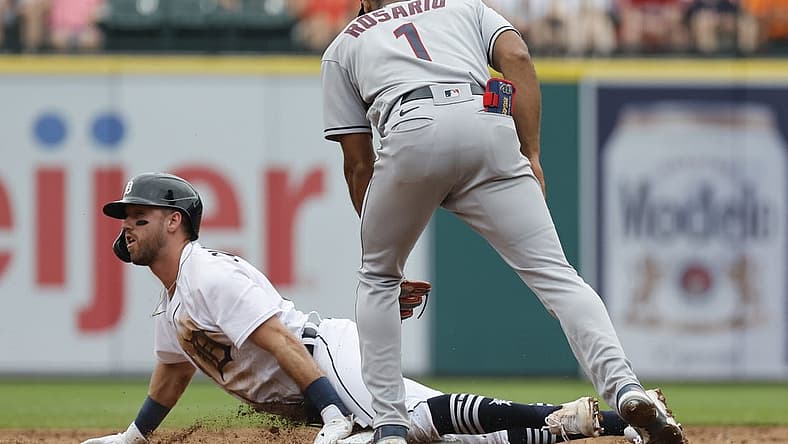 Jul 6, 2022; Detroit, Michigan, USA; Detroit Tigers third baseman Kody Clemens (21) slides safely at second under the tag by Cleveland Guardians shortstop Amed Rosario (1) during second inning at Comerica Park. Mandatory Credit: Rick Osentoski-USA TODAY Sports