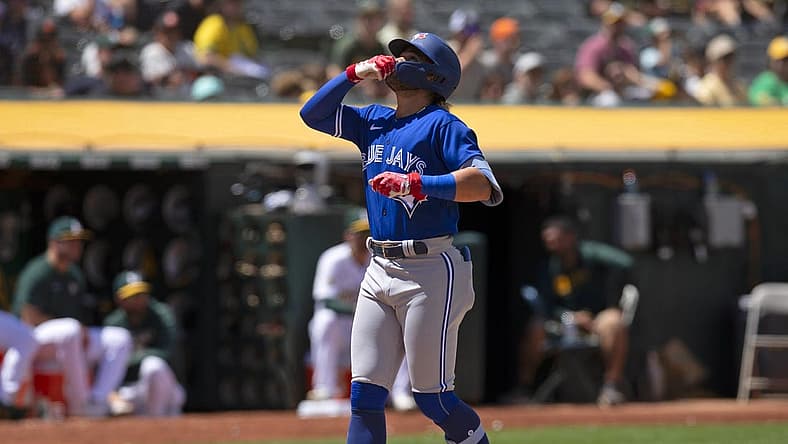 Jul 6, 2022; Oakland, California, USA; Toronto Blue Jays shortstop Bo Bichette (11) celebrates after hitting a solo home run against the Oakland Athletics during the eighth inning at RingCentral Coliseum. Mandatory Credit: D. Ross Cameron-USA TODAY Sports