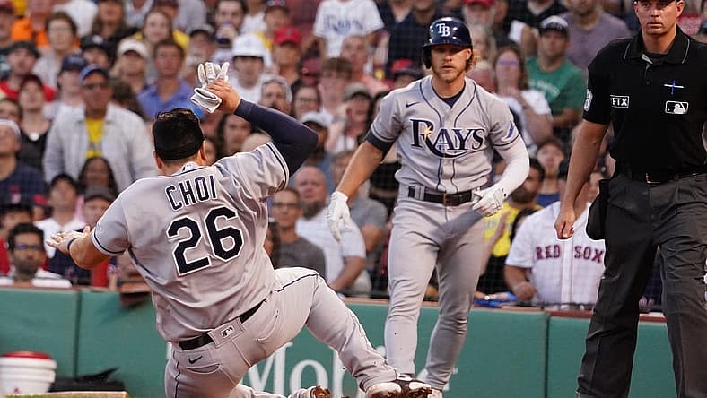 Jul 6, 2022; Boston, Massachusetts, USA; Tampa Bay Rays first baseman Ji-Man Choi (26) slides into home plate to score against the Boston Red Sox in the third inning at Fenway Park. Mandatory Credit: David Butler II-USA TODAY Sports