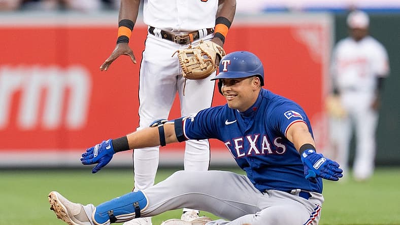 Jul 6, 2022; Baltimore, Maryland, USA; Texas Rangers first baseman Nathaniel Lowe (30) celebrates after hitting a double during the second inning at Oriole Park at Camden Yards. Mandatory Credit: Jessica Rapfogel-USA TODAY Sports