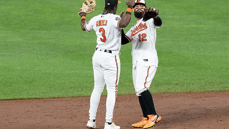 Jul 6, 2022; Baltimore, Maryland, USA; Baltimore Orioles shortstop Jorge Mateo (3) and second baseman Rougned Odor (12) celebrate after defeating the Texas Rangers at Oriole Park at Camden Yards. Mandatory Credit: Jessica Rapfogel-USA TODAY Sports