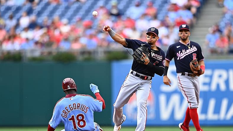 Jul 7, 2022; Philadelphia, Pennsylvania, USA; Washington Nationals second baseman Cesar Hernandez (1) attempts to turn a double play over Philadelphia Phillies shortstop Didi Gregorius (18) in the second inning at Citizens Bank Park. Mandatory Credit: Kyle Ross-USA TODAY Sports