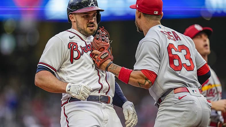 Jul 7, 2022; Cumberland, Georgia, USA; Atlanta Braves left fielder Adam Duvall (14) is tagged out in a run down by St. Louis Cardinals shortstop Edmundo Sosa (63) during the second inning at Truist Park. Mandatory Credit: Dale Zanine-USA TODAY Sports