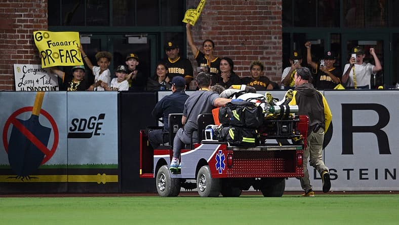 Jul 7, 2022; San Diego, California, USA; San Diego Padres left fielder Jurickson Profar (10) is carted away after a collision with shortstop C.J. Abrams (not pictured) during the fifth inning against the San Francisco Giants at Petco Park. Mandatory Credit: Orlando Ramirez-USA TODAY Sports