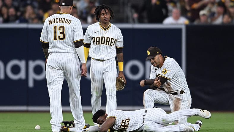 Jul 7, 2022; San Diego, California, USA; San Diego Padres shortstop baseman C.J. Abrams (top, center) and left fielder Jurickson Profar (bottom) react after colliding during the fifth inning against the San Francisco Giants at Petco Park. Mandatory Credit: Orlando Ramirez-USA TODAY Sports
