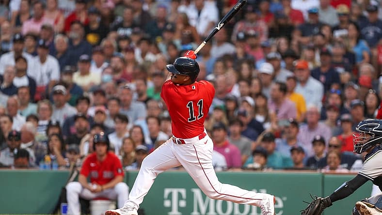 Jul 7, 2022; Boston, Massachusetts, USA; Boston Red Sox third baseman Rafael Devers (11) hits a home run during the third inning against the New York Yankees at Fenway Park. Mandatory Credit: Paul Rutherford-USA TODAY Sports