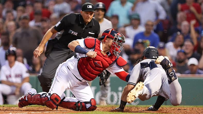 Jul 8, 2022; Boston, Massachusetts, USA; New York Yankees right fielder Joey Gallo (13) is tagged out at home by Boston Red Sox catcher Christian Vazquez (7) during the third inning at Fenway Park. Mandatory Credit: Paul Rutherford-USA TODAY Sports
