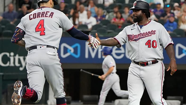 Jul 8, 2022; Arlington, Texas, USA; Minnesota Twins shortstop Carlos Correa (4) celebrates with third base coach Tommy Watkins (40) after hitting a two run home run against the Texas Rangers during the first inning at Globe Life Field. Mandatory Credit: Jim Cowsert-USA TODAY Sports