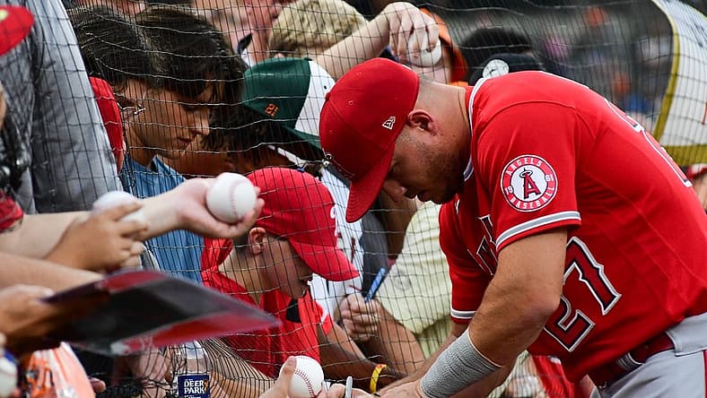 Jul 8, 2022; Baltimore, Maryland, USA; Los Angeles Angels center fielder Mike Trout (27) sings autographs before the game against the Baltimore Orioles at Oriole Park at Camden Yards. Mandatory Credit: Tommy Gilligan-USA TODAY Sports