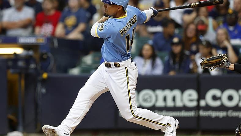 Jul 8, 2022; Milwaukee, Wisconsin, USA; Milwaukee Brewers right fielder Jace Peterson (14) hits an RBI single during the fourth inning against the Pittsburgh Pirates at American Family Field. Mandatory Credit: Jeff Hanisch-USA TODAY Sports