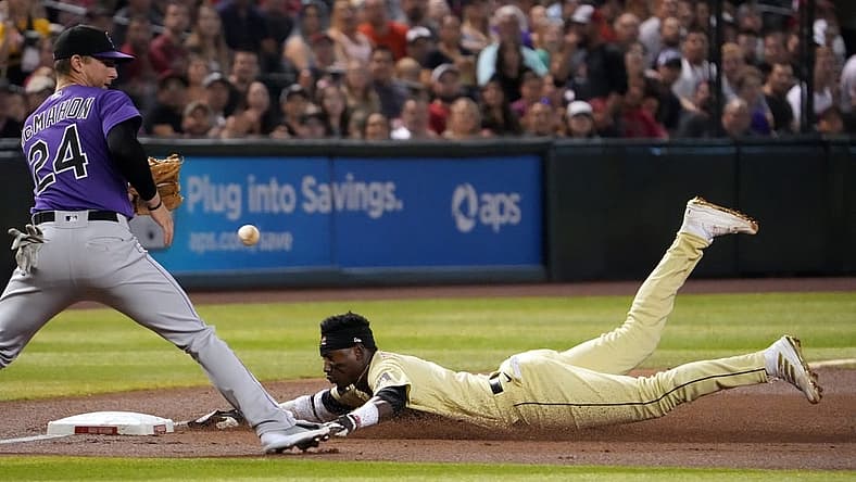 Jul 8, 2022; Phoenix, Arizona, USA; Arizona Diamondbacks shortstop Geraldo Perdomo (2) reaches base safely against Colorado Rockies third baseman Ryan McMahon (24) during the second inning at Chase Field. Mandatory Credit: Joe Camporeale-USA TODAY Sports